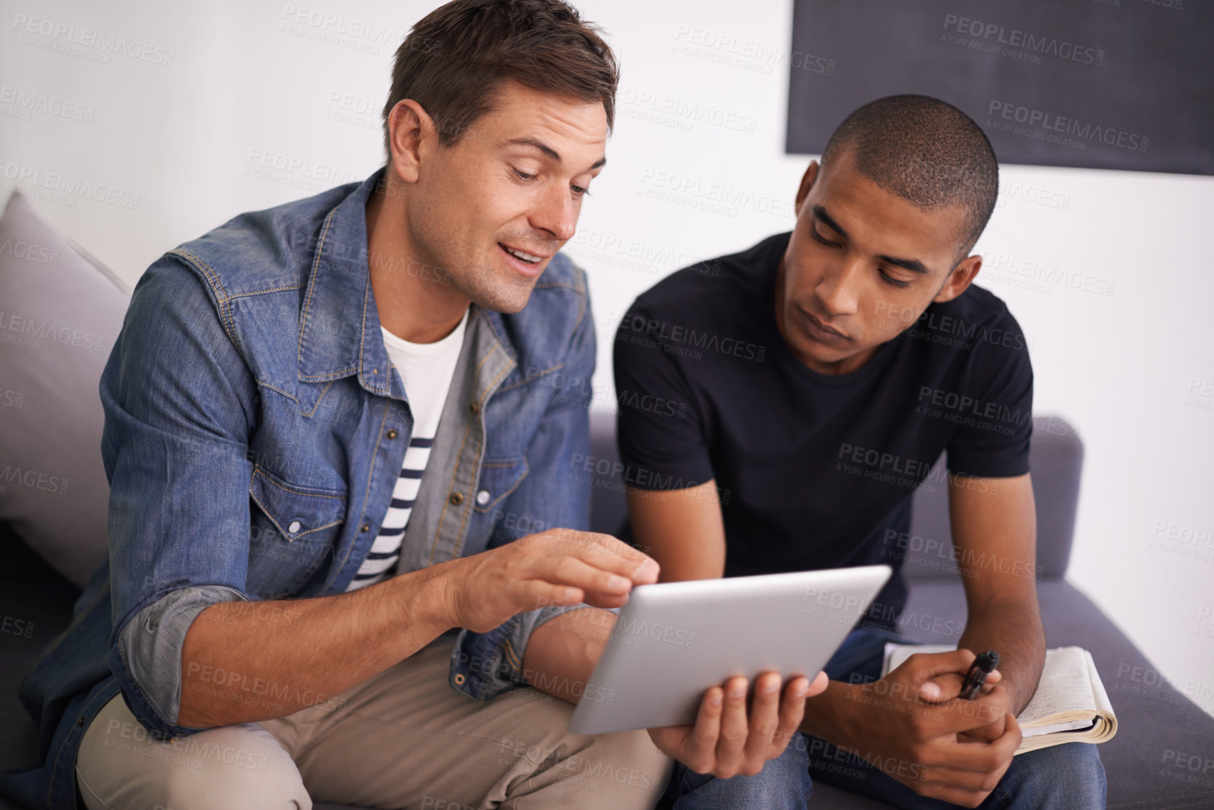 Buy stock photo Men, sofa and tablet in office with discussion for research, creative startup and feedback on project. Employees, communication and technology with notebook for planning, networking and brainstorming