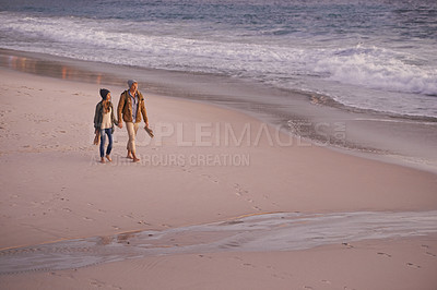 Buy stock photo Couple, holding hands and love for walking on shore, ocean waves and peace for romance in relationship. People, beach and security in marriage, sea and travel together on vacation or holiday for date