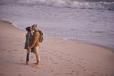 Buy stock photo Couple, kiss and love in nature by beach, ocean wave and peace for romance in relationship. People, affection and security in marriage, sea and travel together on vacation or holiday for outdoor date