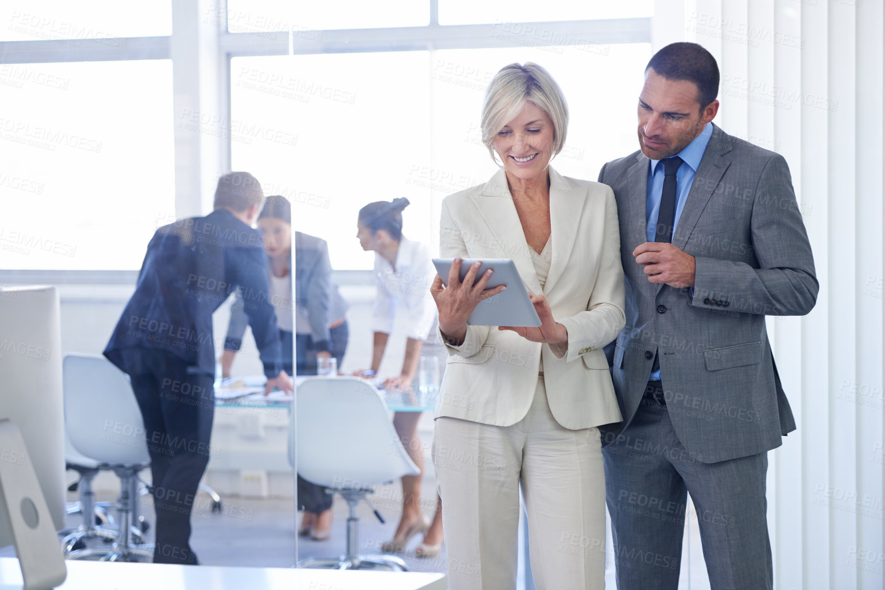 Buy stock photo Cropped shot of a group of business colleagues meeting in the boardroom