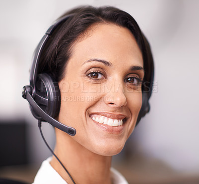 Buy stock photo Portrait of an attractive young office worker wearing a headset