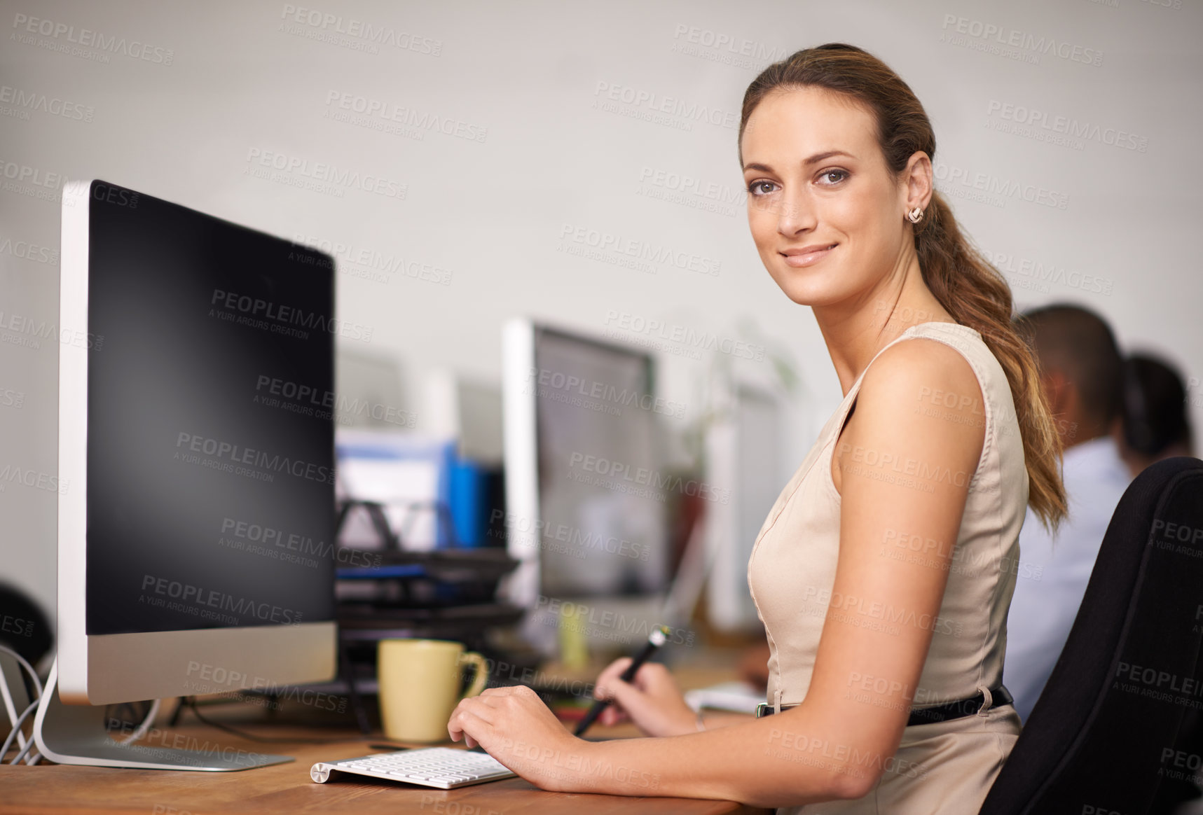 Buy stock photo Portrait of an attractive young office worker at her computer