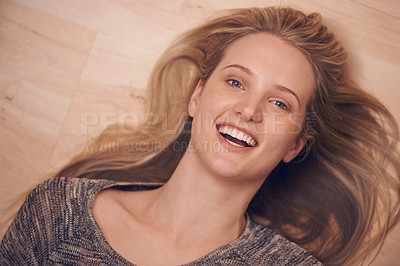 Buy stock photo Happy, portrait and woman on a floor with confidence, positive attitude or feel good mood from above. Face, smile and female person relax in a living room on day off, weekend or vacation in her home