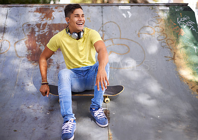 Buy stock photo Skateboard, happy and man in skate park for training, exercise and skating in city. Skater, fashion and teenager laughing in trendy, casual outfit and street style for sports, fun hobby and fitness