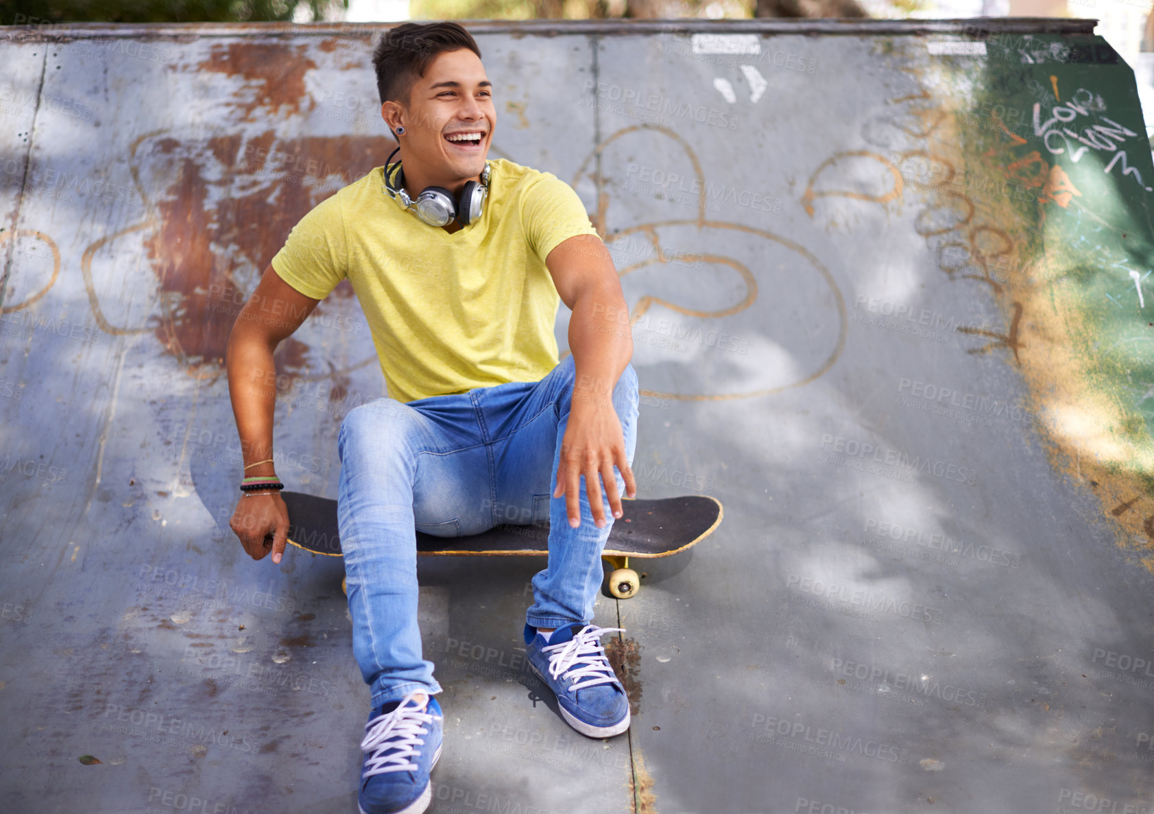 Buy stock photo Skateboard, happy and man in skate park for training, exercise and skating in city. Skater, fashion and teenager laughing in trendy, casual outfit and street style for sports, fun hobby and fitness