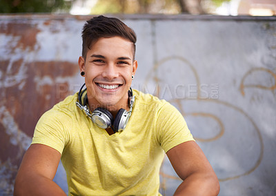 Buy stock photo Smile, portrait and young man at skatepark for skating practice or training for competition. Happy, gen z and face of cool male person sitting on ramp with positive, good and confident attitude.