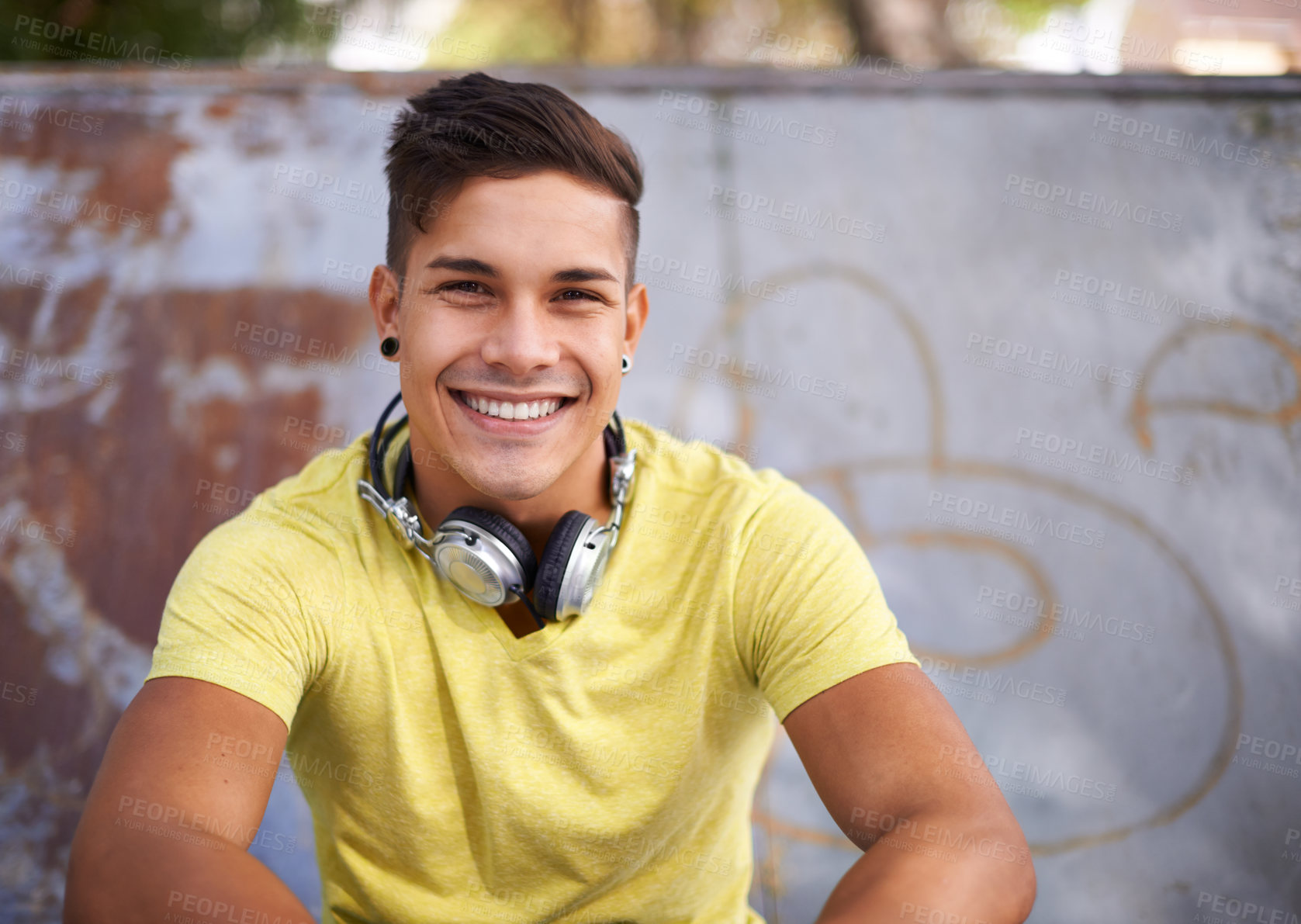 Buy stock photo Smile, portrait and young man at skatepark for skating practice or training for competition. Happy, gen z and face of cool male person sitting on ramp with positive, good and confident attitude.