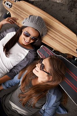 Buy stock photo Happy, friends and above of women with skateboard for exercise, training and competition in city. Skate park, fashion and young people in trendy, casual and street style for sports, hobby and fitness