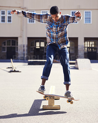 Buy stock photo Man, skateboard and balance with riding at skatepark, sport and energy with skill, stunt and recreation outdoor. Skateboarder, technique and trick, action with training and workout for exercise