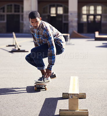 Buy stock photo Man, skateboard and riding at urban skatepark, sports and energy with skill, stunt and recreation activity outdoor. Skateboarder, technique and trick, training and workout for balance and exercise