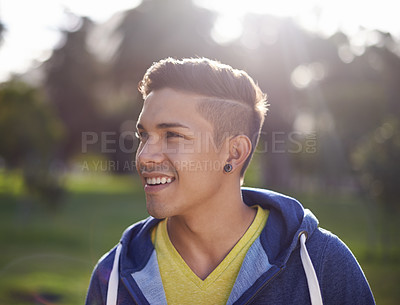 Buy stock photo Smile, happy and young man outdoor in nature, environment and park to relax on break with closeup. Male person, student gen z guy and student enjoying summer outside by trees, grass and lens flare