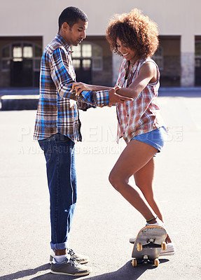 Buy stock photo Happy, learning and man with woman on skateboard in city on romantic and fun date together. Smile, couple and African male skater teaching skating to young girlfriend in urban town with love.