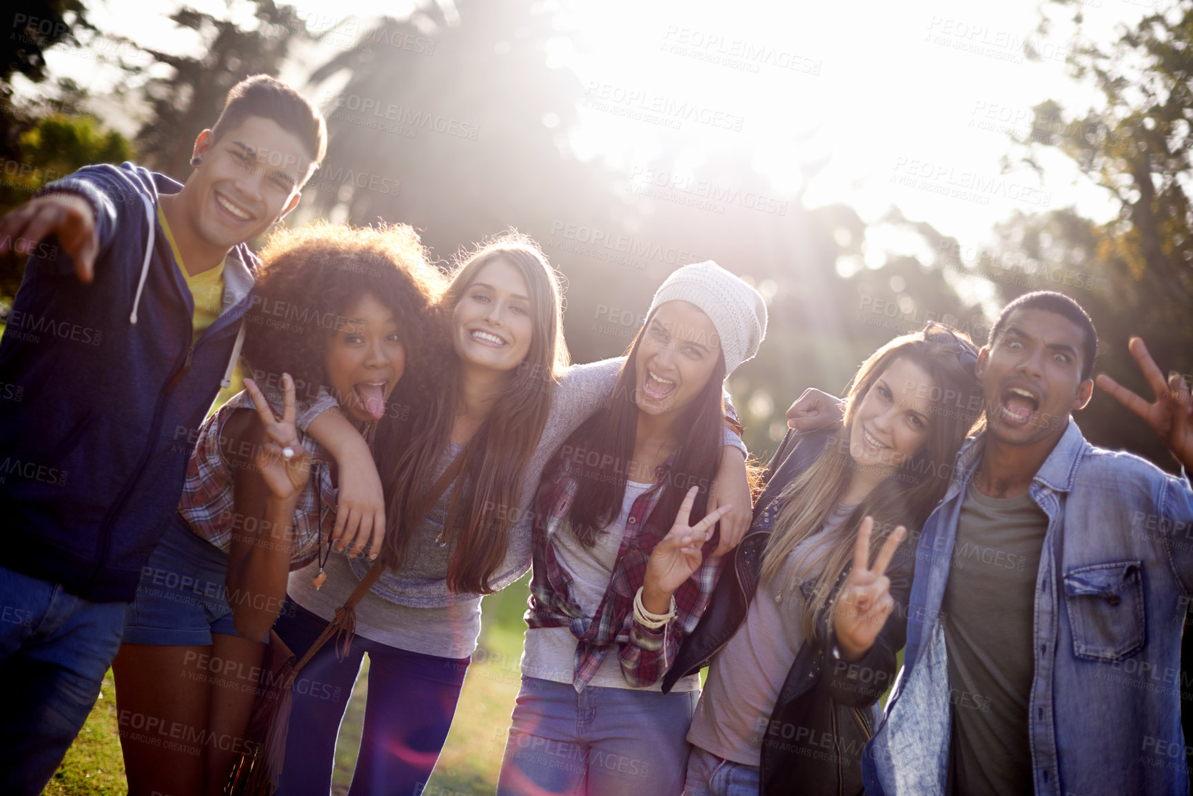 Buy stock photo Cropped portrait of a group of young friends enjoying the outdoors