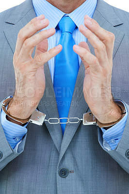 Buy stock photo Businessman, hands and cuffs with strain for theft, crime or corruption on a white studio background. Closeup of man or employee tied up with chain for arrest, criminal or illegal bribery of the law