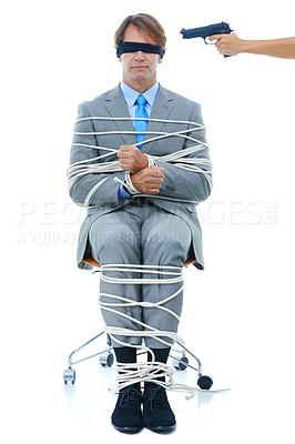 Buy stock photo Businessman, tied up and hostage with gun on chair in kidnapped, robbery or silence on a white studio background. Young man or employee with ropes or handcuffs in crime, theft or corruption on mockup
