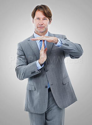 Buy stock photo Portrait, businessman and hand gesture for stop, timeout and isolated on gray background. Professional, suit and manager for accounting firm with sign for pause, corporate and employee in studio