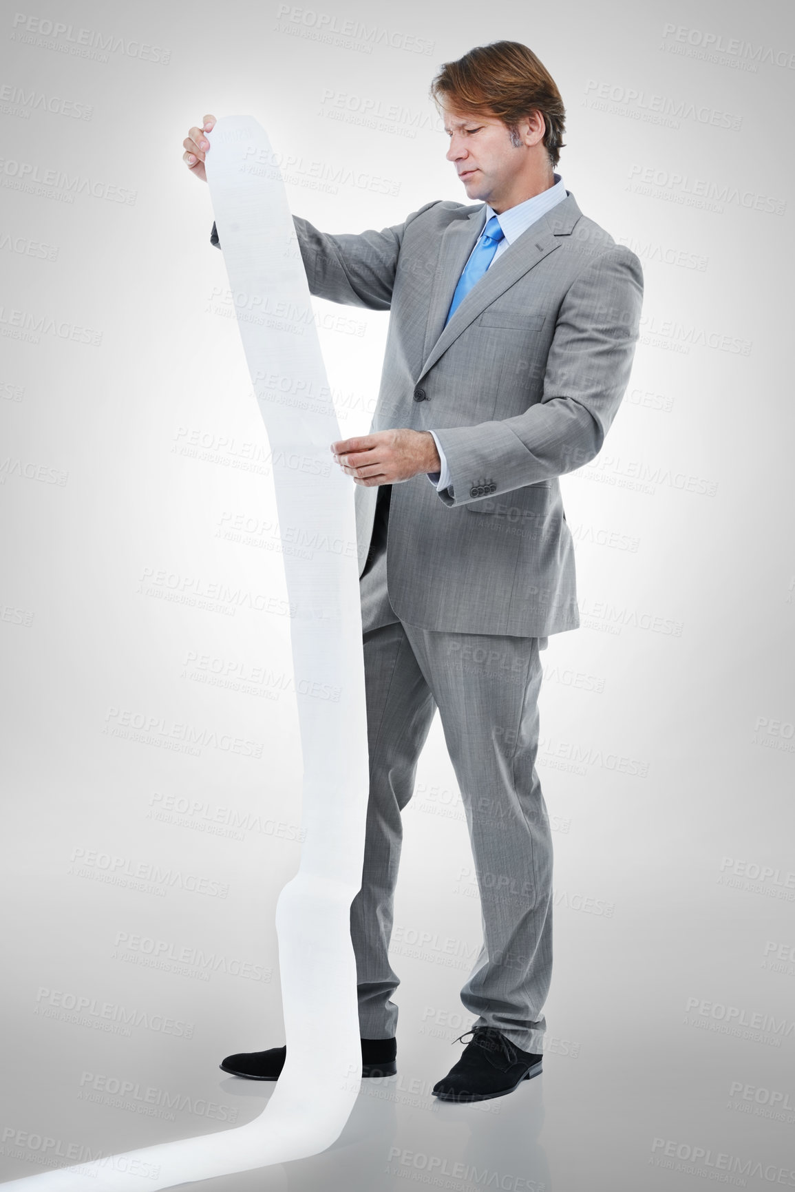 Buy stock photo Businessman, documents and receipt with finance for bills, expenses or list on a gray studio background. Man or employee checking financial paperwork or report for audit or budget planning on mockup