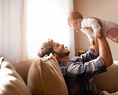 Buy stock photo Shot of a father playing with his baby boy