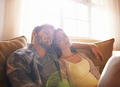 Buy stock photo Shot of a happy young couple asleep on the sofa at home