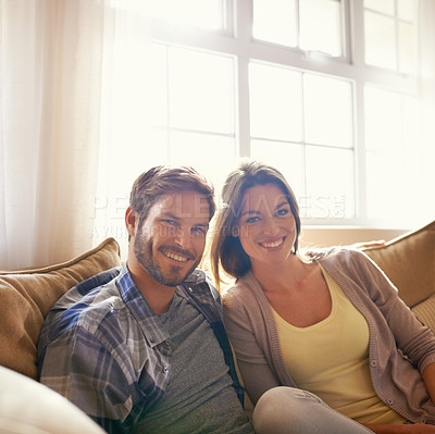 Buy stock photo Cropped shot of a happy young couple relaxing on the sofa at home