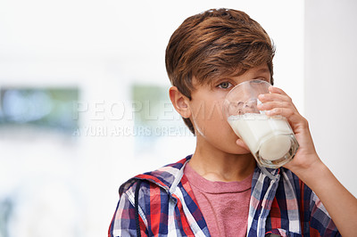 Buy stock photo A young boy drinking a glass of milk