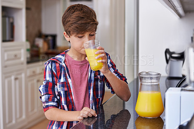 Buy stock photo Children, kitchen and boy drinking orange juice from glass in morning for diet, health or nutrition. Breakfast, cup and kids with young teen in apartment to enjoy fresh beverage for development