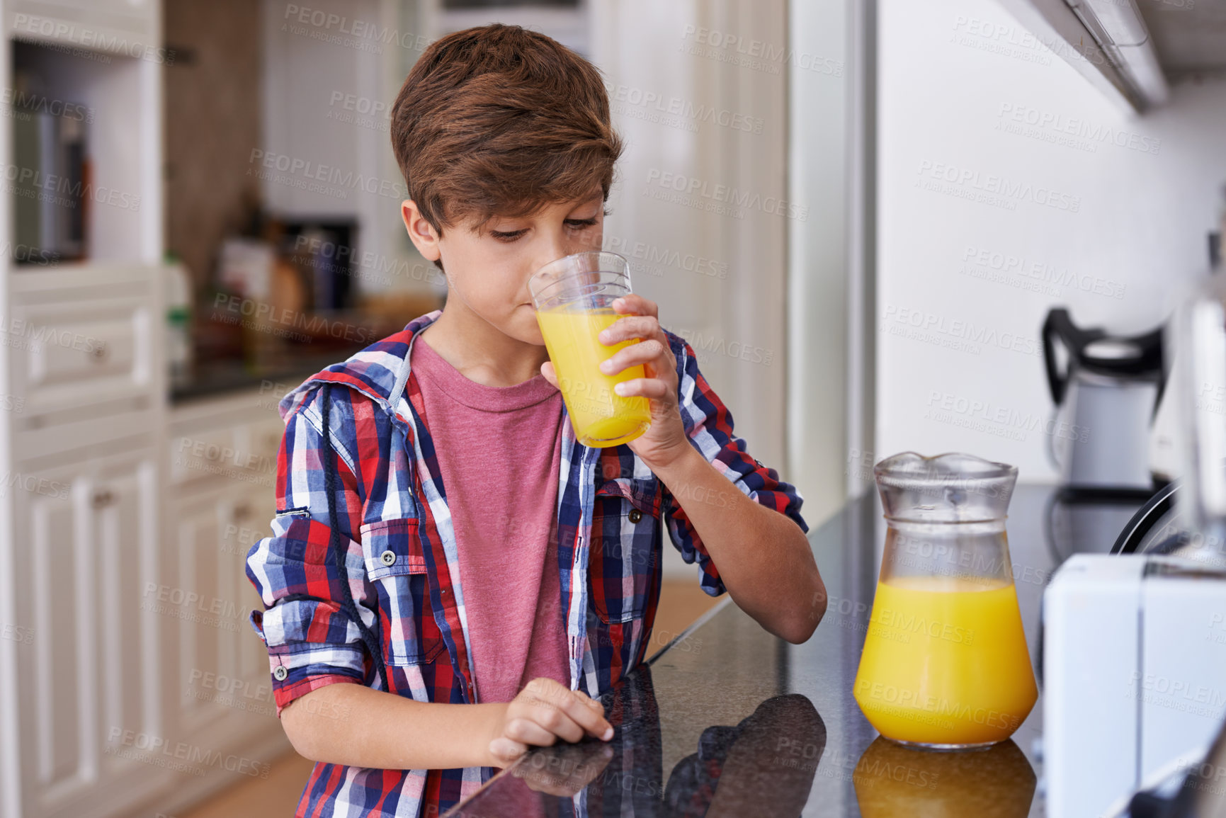 Buy stock photo Children, kitchen and boy drinking orange juice from glass in morning for diet, health or nutrition. Breakfast, cup and kids with young teen in apartment to enjoy fresh beverage for development