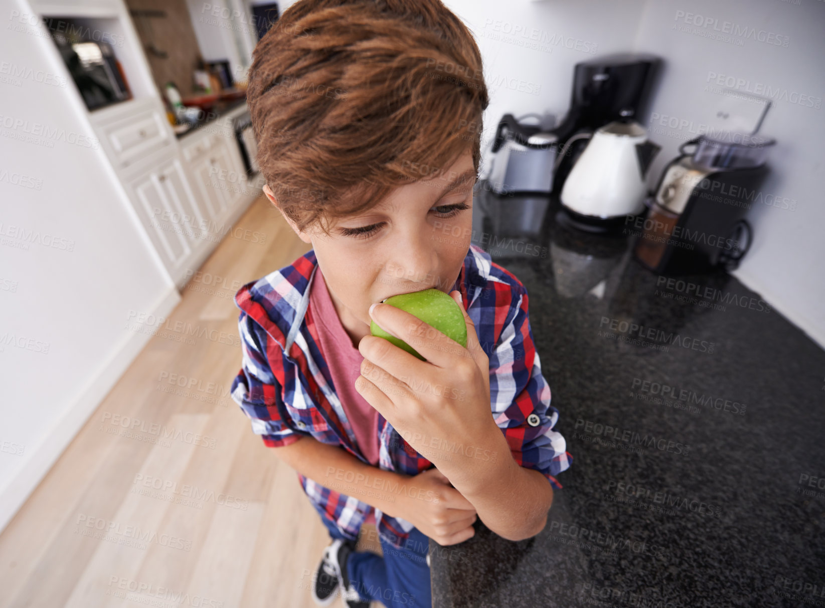 Buy stock photo Face, kitchen and boy biting apple in home as diet, health or nutrition for child development closeup. Food, kids and snack with young teen eating green fruit in apartment for hunger or growth