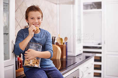 Buy stock photo Eating, cookies and portrait of child in home with glass, container or happy with jar of sweets on kitchen counter. House, snack and craving taste of sugar from addiction to unhealthy food or biscuit