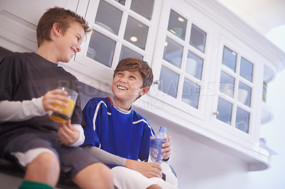 Buy stock photo Kitchen, team and boys with smile for drinks, soccer or football and practice for match with ball. Friends, children and kids ready in house for workout, exercise and training to play sport for game