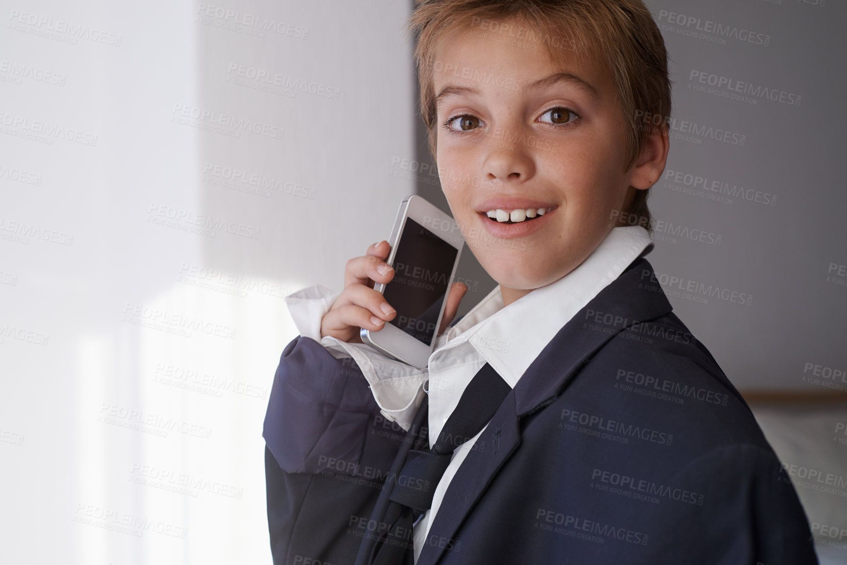 Buy stock photo Child, portrait and phone call in suit for communication connection or dress up costume, home or working. Male person, face and smartphone conversation in apartment for corporate, talking or happy