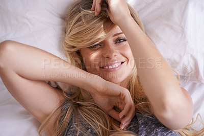 Buy stock photo Cropped shot of a beautiful young woman relaxing in bed