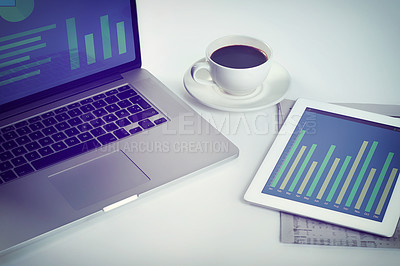 Buy stock photo Cropped shot of a tablet, a laptop and a cup of coffee on a workstation