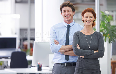 Buy stock photo Cropped shot of two colleagues standing in an office