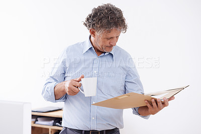 Buy stock photo Man, coffee and documents in office for paperwork or report in morning for review with caffeine for company. Businessman with mug and folder or file for information and results for work and reading
