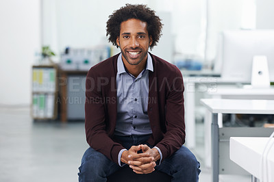 Buy stock photo Shot of a young businessman sitting in an office