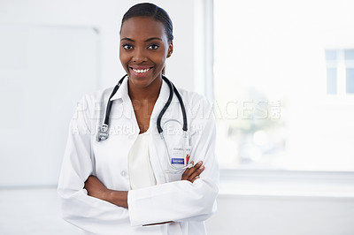 Buy stock photo Portrait of a female doctor standing in a room with her arms crossed