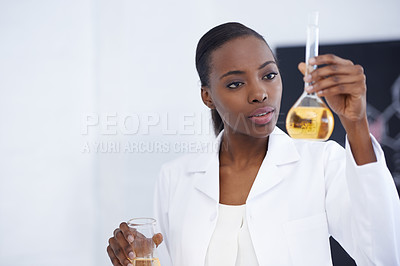 Buy stock photo Shot of an attractive female scientist conducting an experiment in her lab