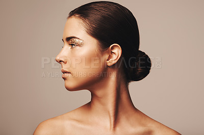 Buy stock photo Profile shot of a beautiful woman wearing gold flakes around her eys