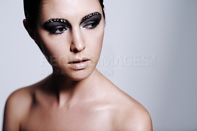 Buy stock photo Studio shot of a beautiful young woman wearing metallic-colored makeup