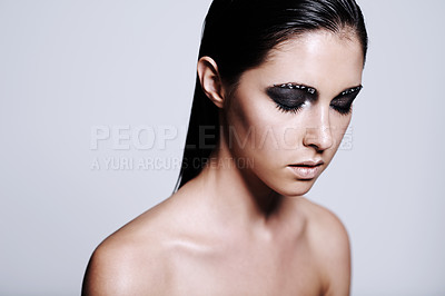 Buy stock photo Woman, face and beauty with makeup, eyeshadow or cosmetics on a gray studio background. Young female person, brunette or model with gothic style in skincare, salon or facial treatment on mockup space