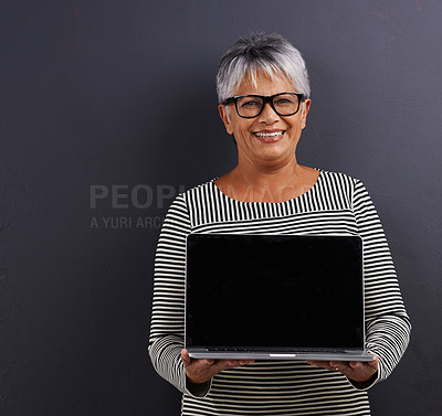 Buy stock photo Laptop, screen and portrait of mature woman in studio background learning about technology in mockup. Senior, person and advertising education on computer for communication, connection and networking