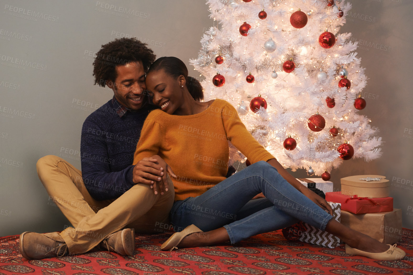Buy stock photo Christmas, tree and black couple in home with love on holiday or hug on vacation with happiness. Festive, house and people embrace with care and support or excited to celebrate at event together