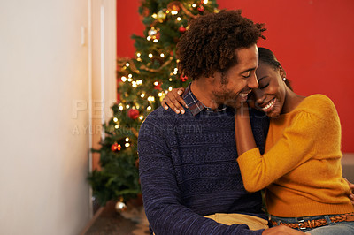 Buy stock photo Couple, embrace and Christmas holiday at tree in apartment living room for festive season celebration, vacation or decoration. Man, woman and hug bonding for relaxing connection, present or break