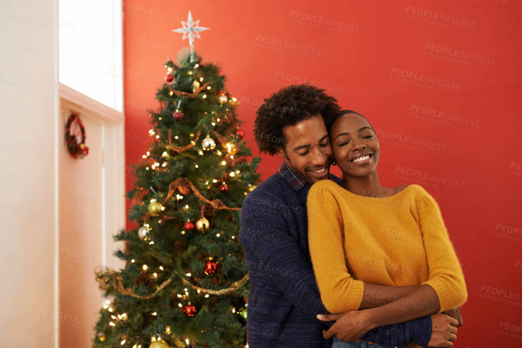 Buy stock photo Couple, Christmas tree and festive holiday in house with happiness fr vacation celebration, gifts or bonding. Man, woman and smile with lighting decoration for winter season event, together or lounge