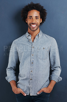 Buy stock photo Happy man, portrait and confident in studio as creative professional and casual fashion by blue background. Young person, face or smile for ambition as designer in trendy clothes or pride in mock up
