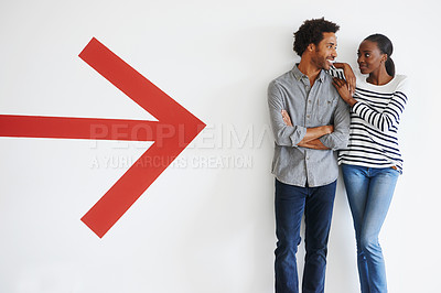 Buy stock photo Couple, love and happiness with arrow by wall in car park with mockup space and romance with smile. African people, embrace and arms crossed in parking area with direction, sign and symbol of icon