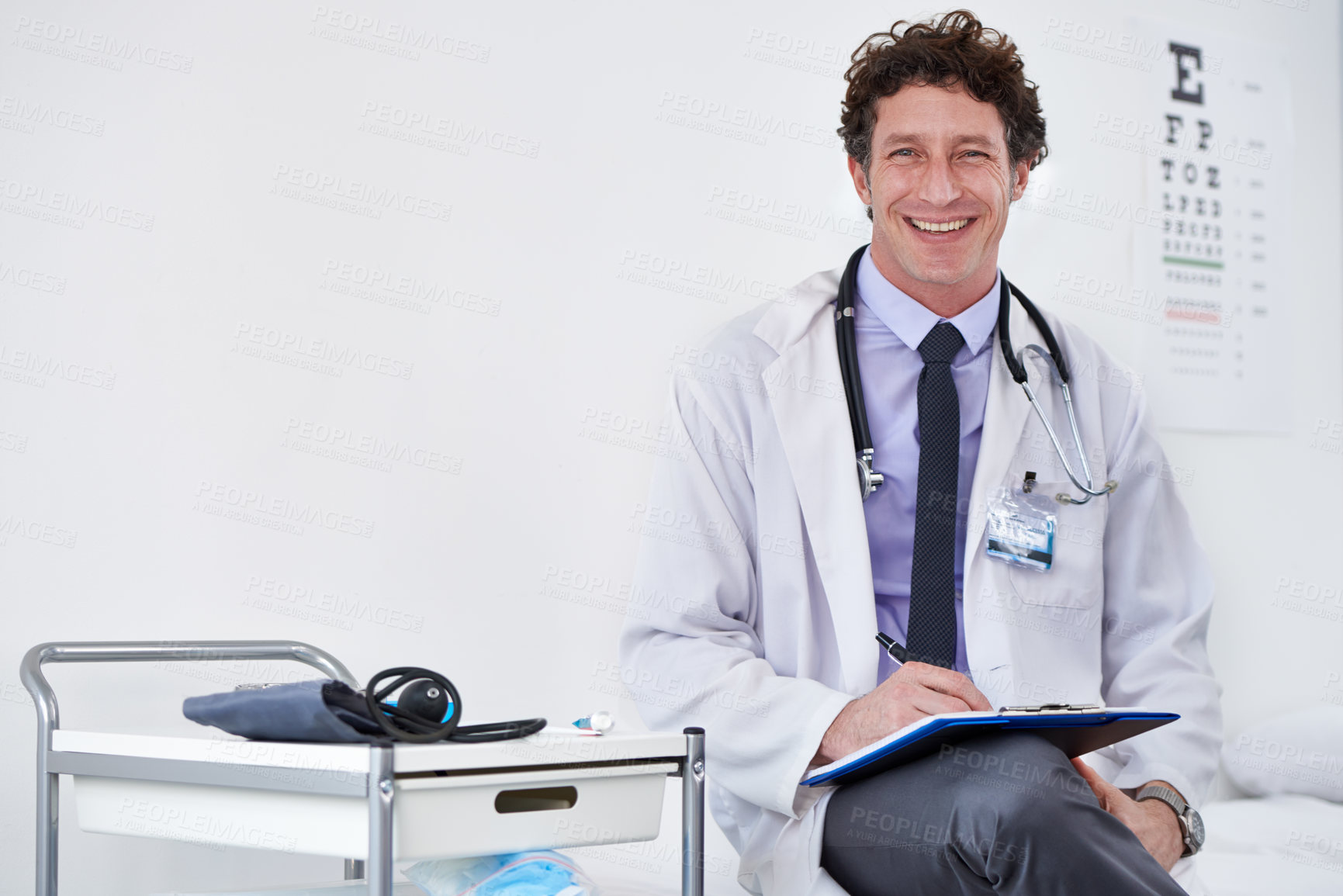Buy stock photo Portrait of a male doctor reading a report
