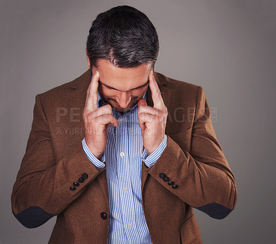 Buy stock photo Business man, headache and stress in studio, burnout and fear or temple massage for pain. Male person, migraine and gray background for mental health, frustration and overwhelmed by pressure