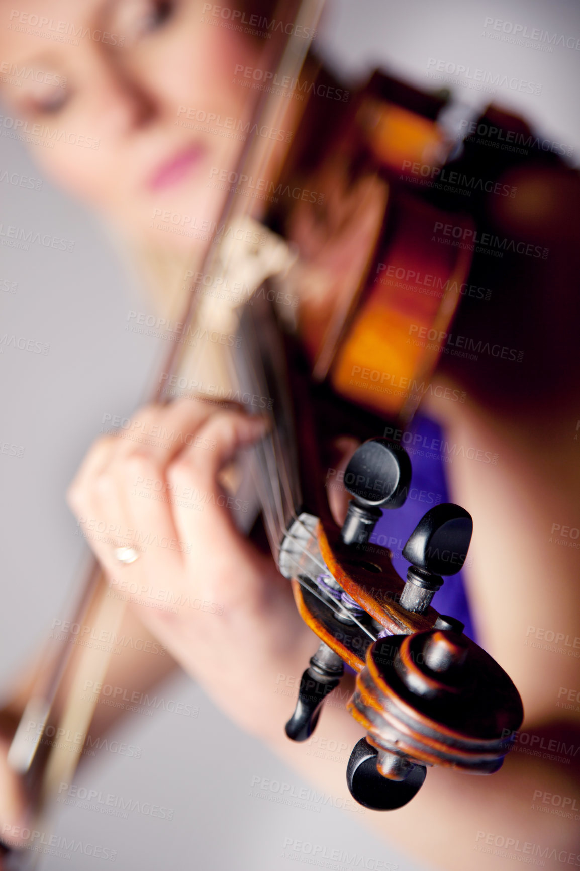 Buy stock photo Studio shot of a beautiful young woman playing the violin